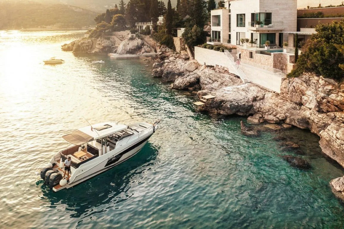 Motor yacht in the bay below Villa Anthon at sunset