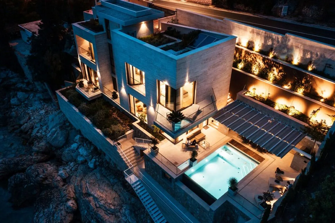 Night aerial view of the terraces and pool at Villa Anthon
