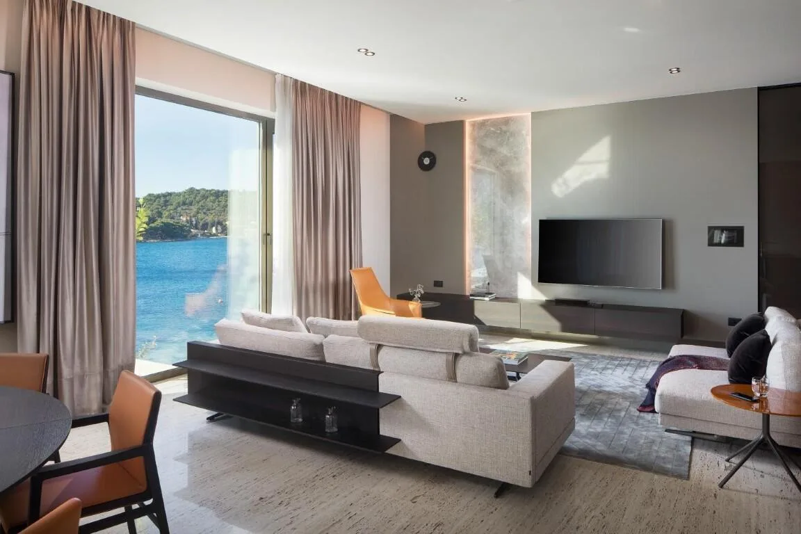 Living room with sofa and floor-to-ceiling sea views at Villa Anthon
