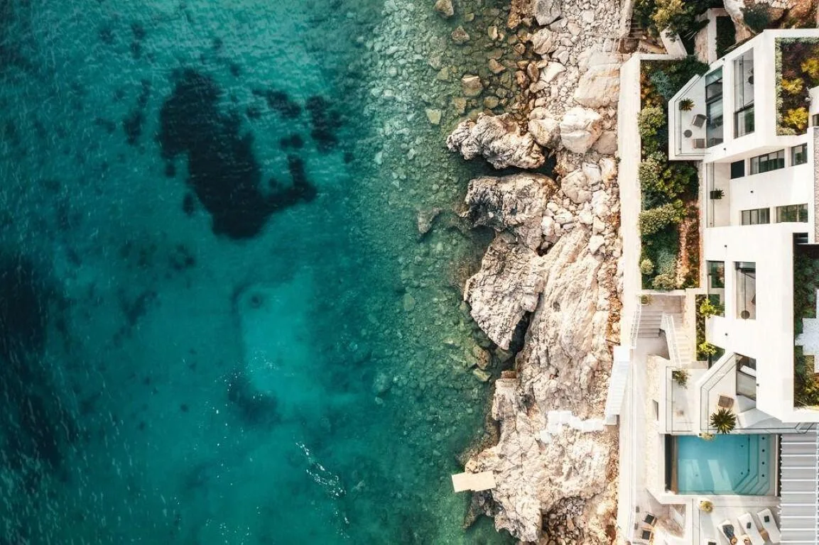 Aerial view of the clear sea and terraces of Villa Anthon