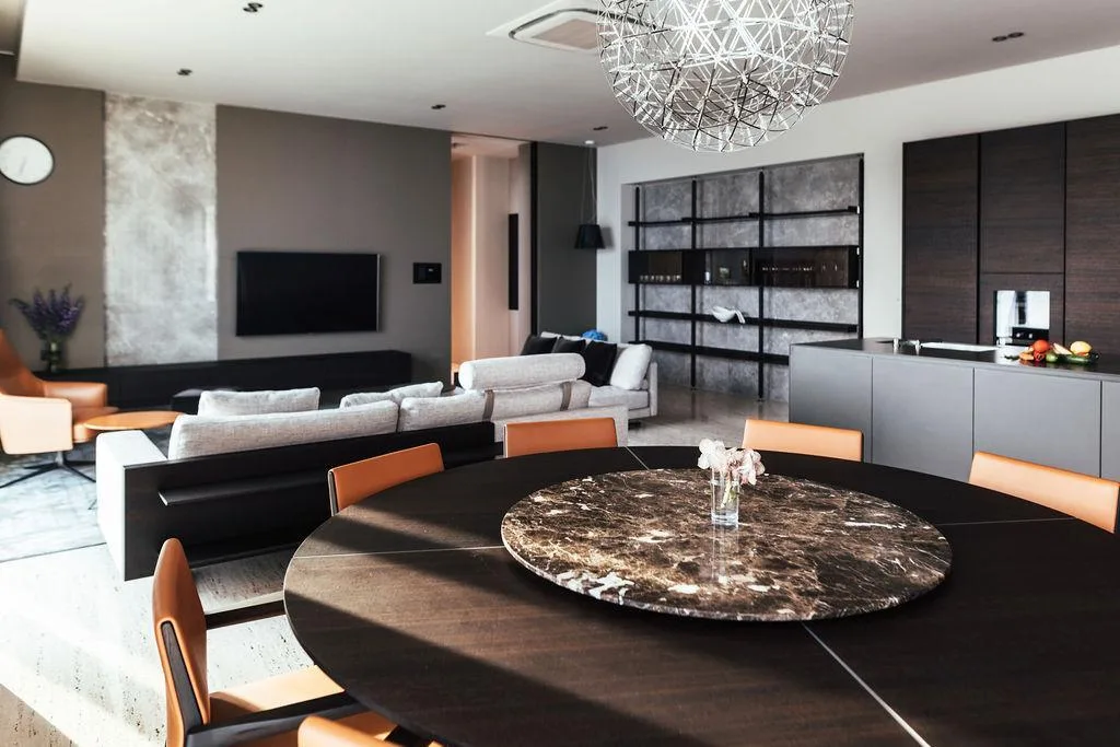 Round marble dining table and living room at Villa Anthon