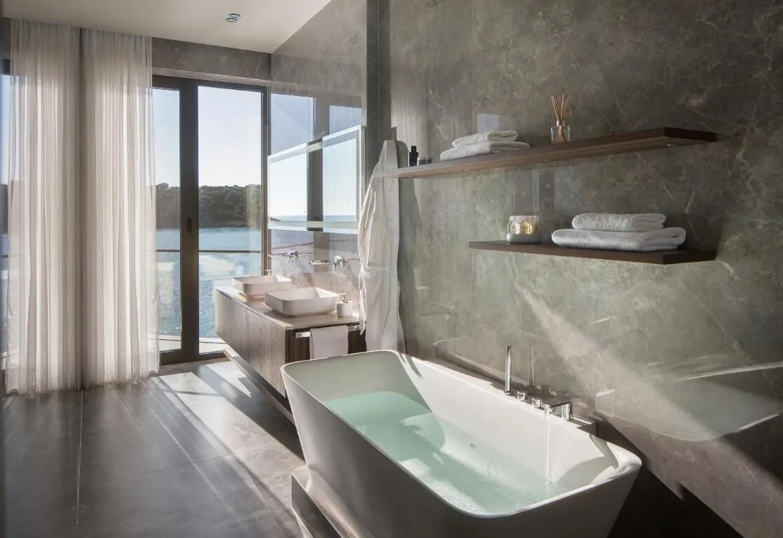 Bathroom with freestanding bathtub and sea view at Villa Anthon
