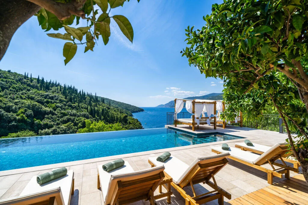 Infinity pool with canopy daybed overlooking Molunat bay at Villa Molunat, Konavle