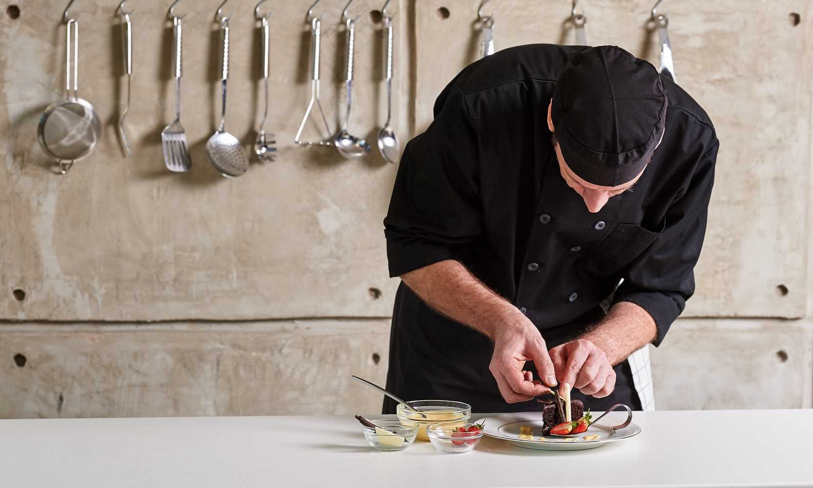 Private chef plating a dish in the kitchen of a Dubrovnik villa