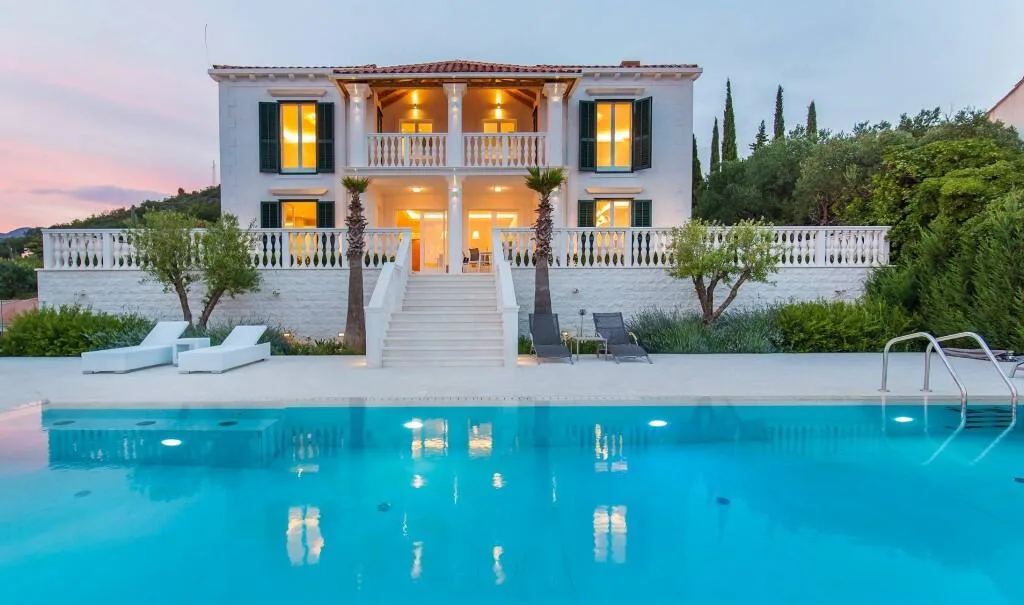 White Mediterranean villa with balustrade terrace and pool at Villa Vintage