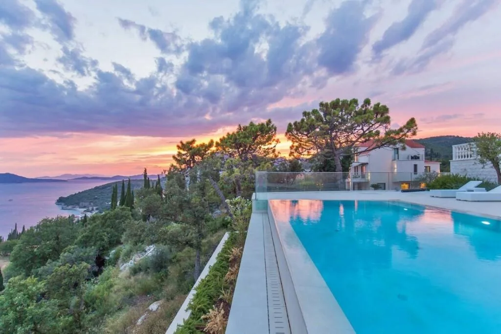 Pool with sea and island views at sunset at Villa Vintage