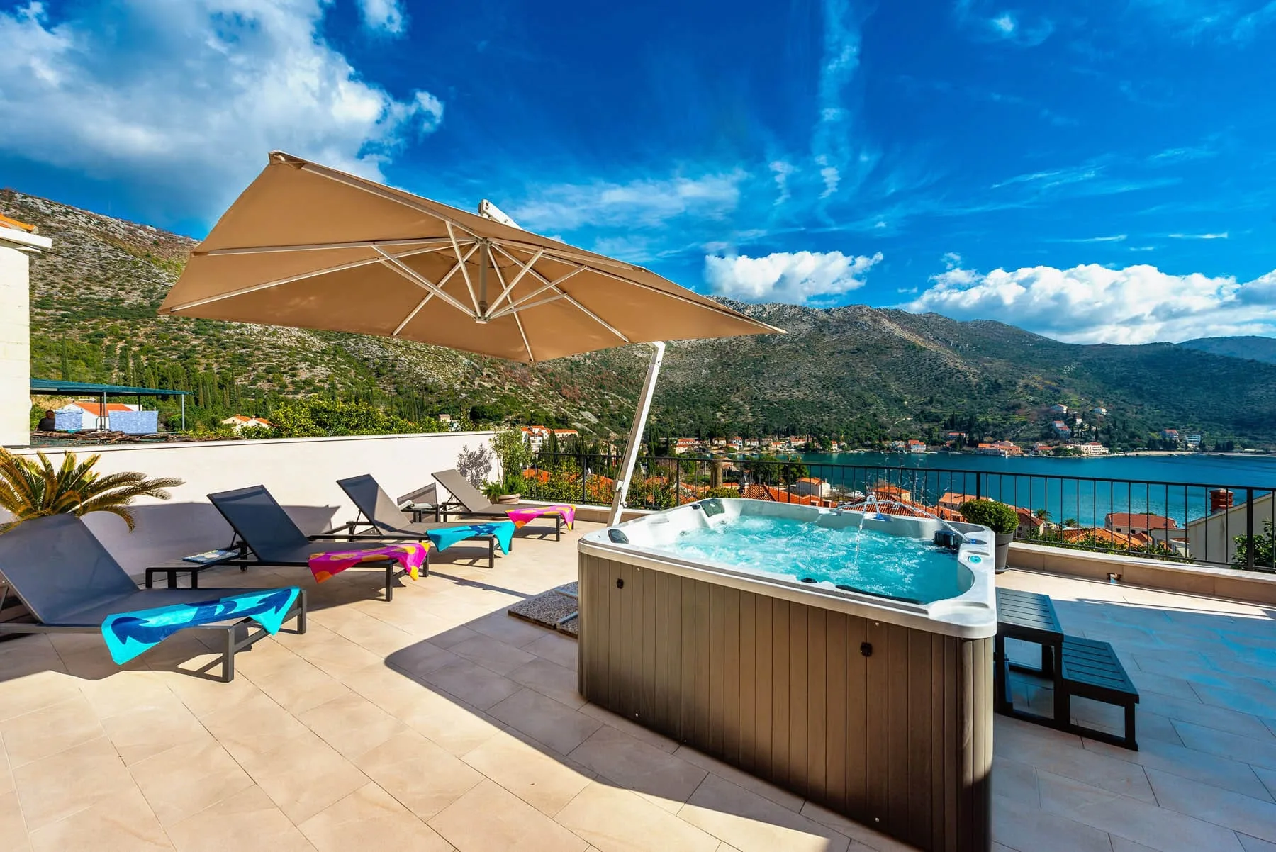 Roof terrace with private hot tub, loungers and views over Zaton Bay at House T