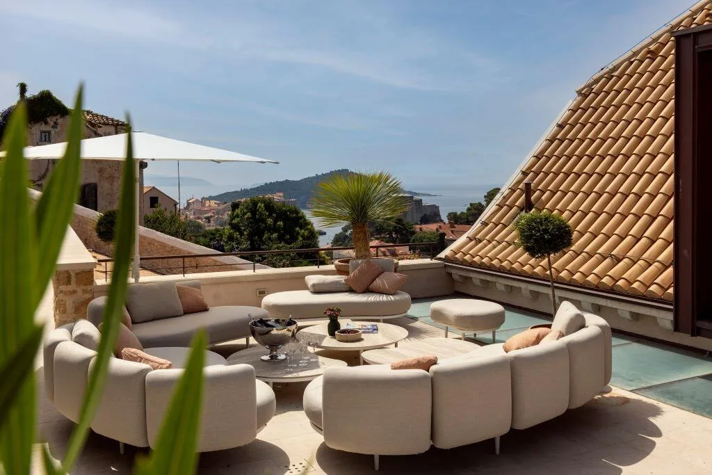 Rooftop terrace lounge with sofas and sea view at Villa La Rose