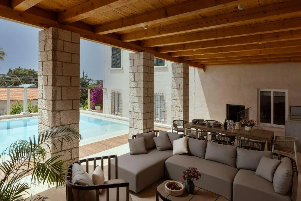 Private pool and covered lounge with stone columns at Villa La Rose