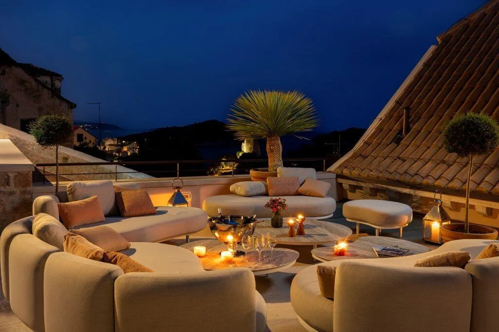 Terrace lounge with candles and lanterns at night at Villa La Rose