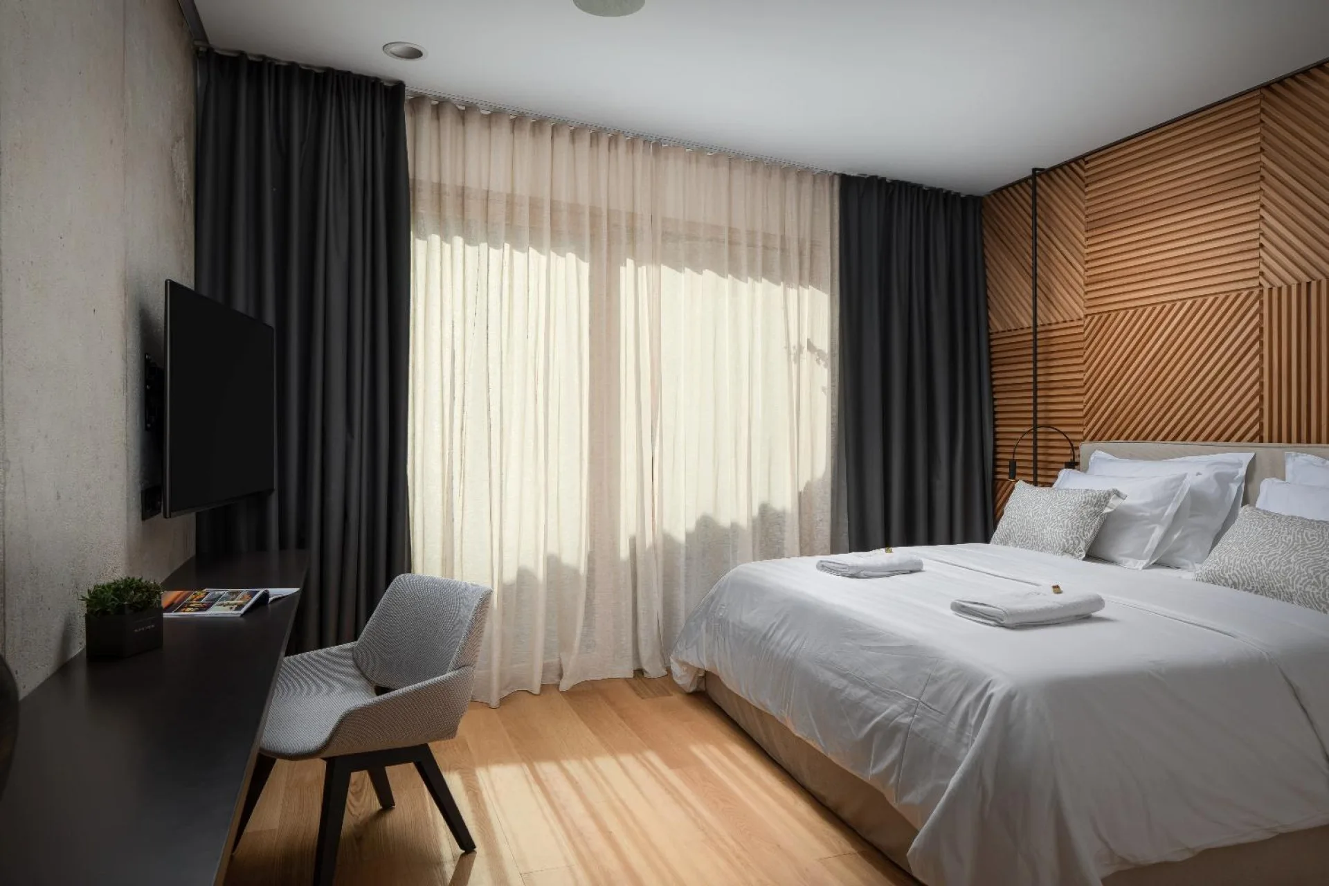 Bedroom with king-size bed and armchair at Villa Palazzo