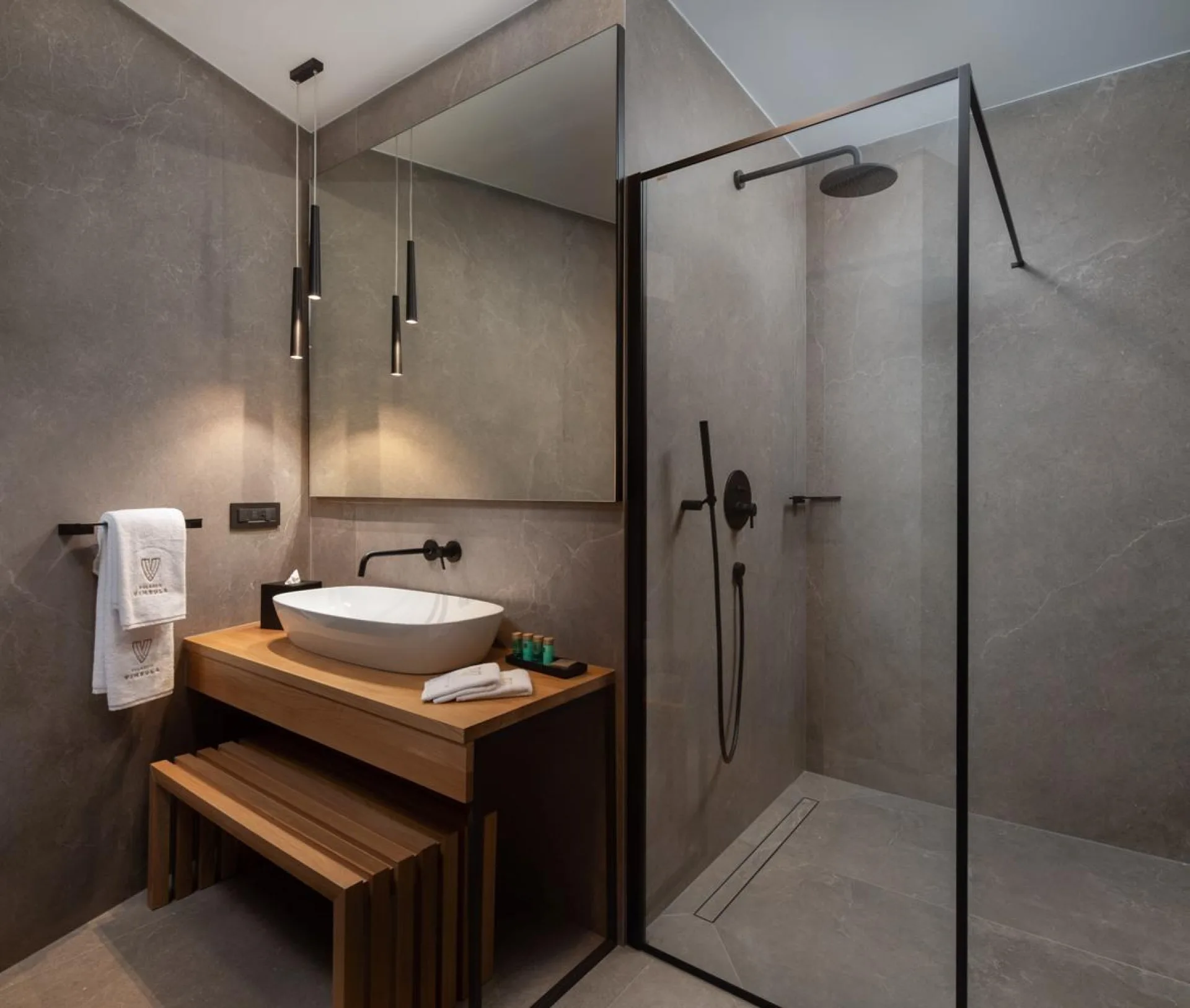 Bathroom with walk-in shower and wooden vanity at Villa Palazzo