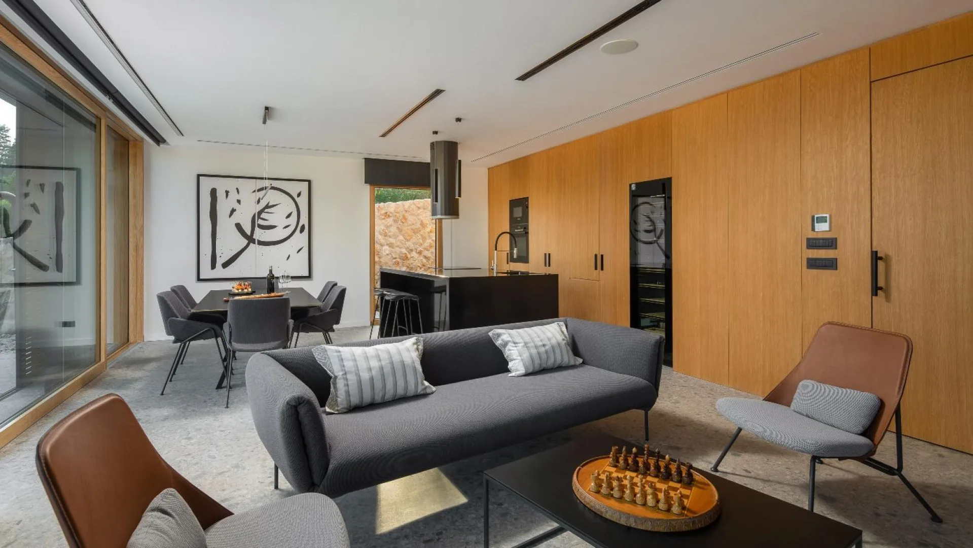 Open-plan living and dining with artwork at Villa Palazzo