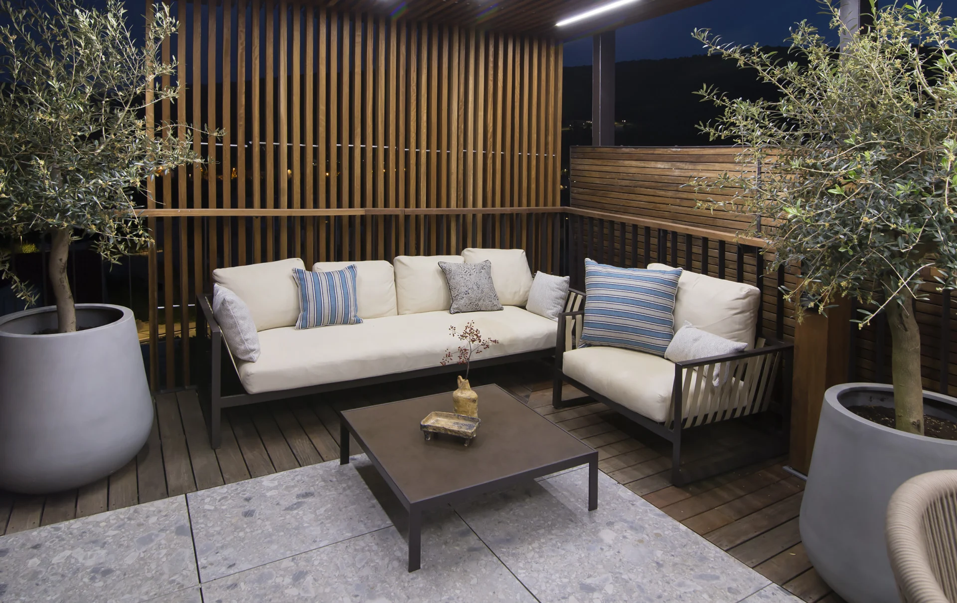 Terrace lounge with sofa and olive trees at Villa Palazzo