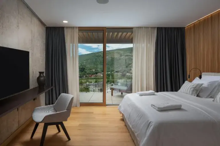 Bedroom with king-size bed and terrace view at Villa Palazzo