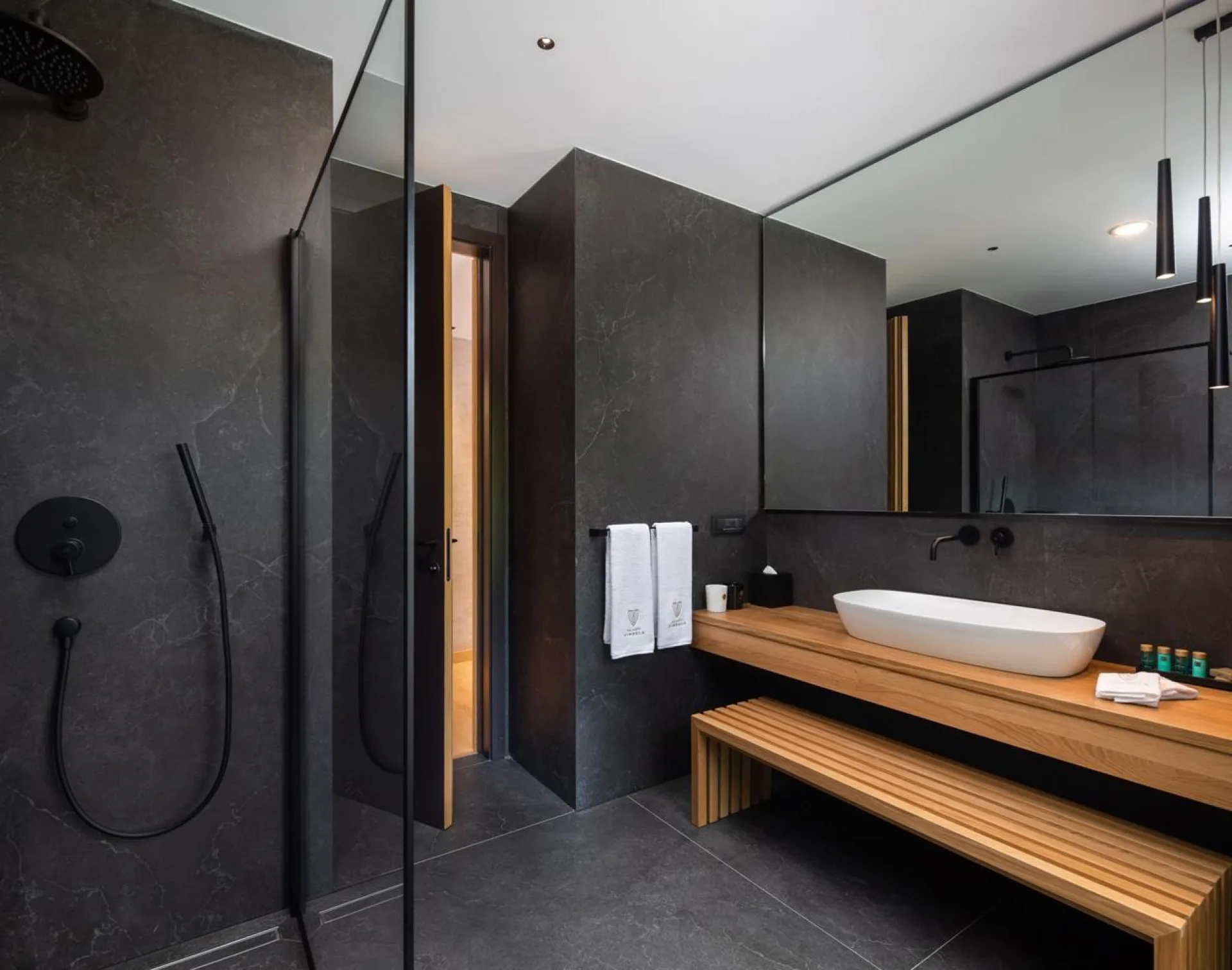 Dark stone bathroom with vessel basin at Villa Palazzo