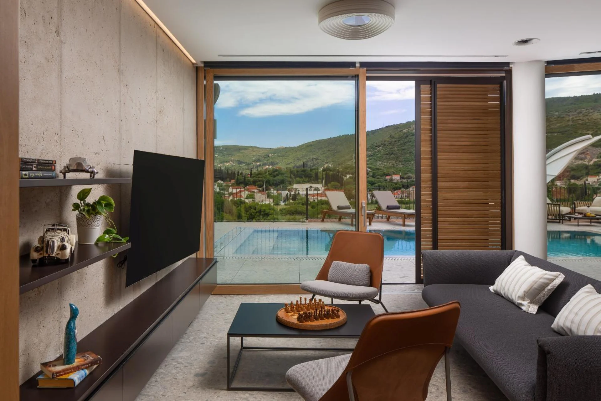 Living area with sofa and glass doors to the pool at Villa Palazzo