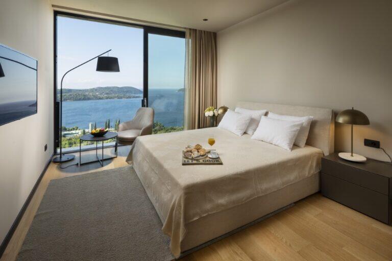 Schlafzimmer mit Kingsize-Bett und Meerblick in der Villa Elena