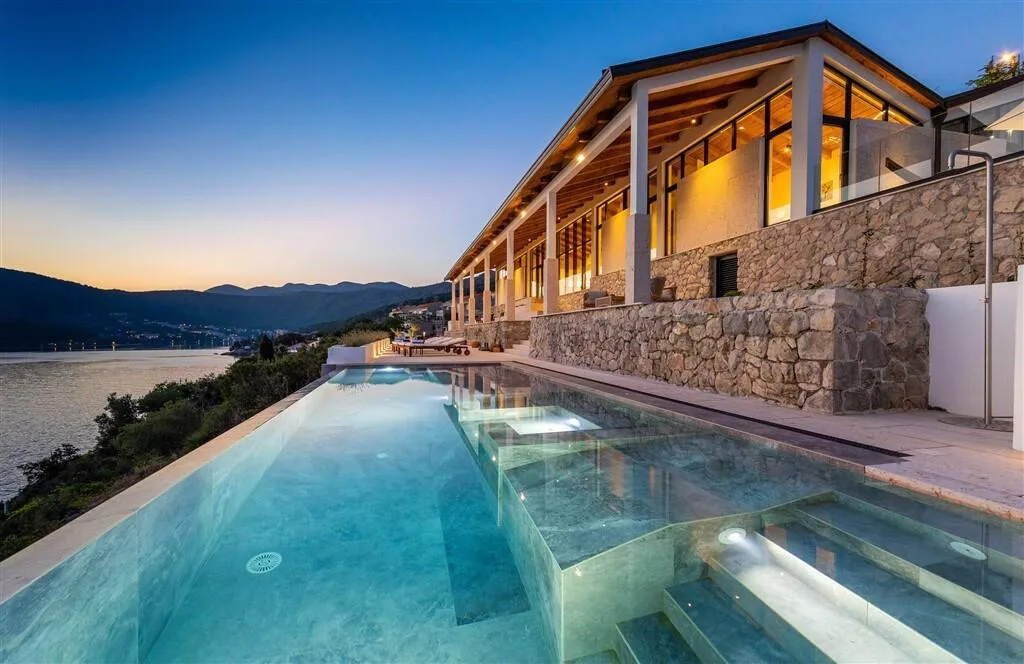 Infinity pool at sunset along the stone villa at Villa Moa, Štikovica