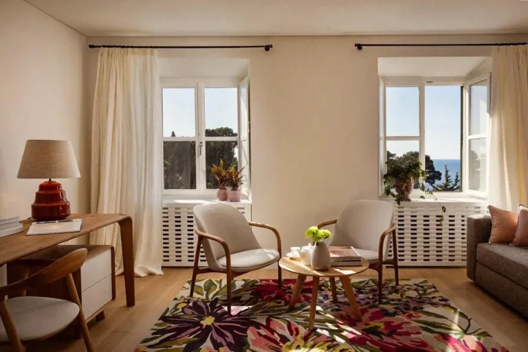 Bedroom sitting area with armchairs and desk at Villa La Rose