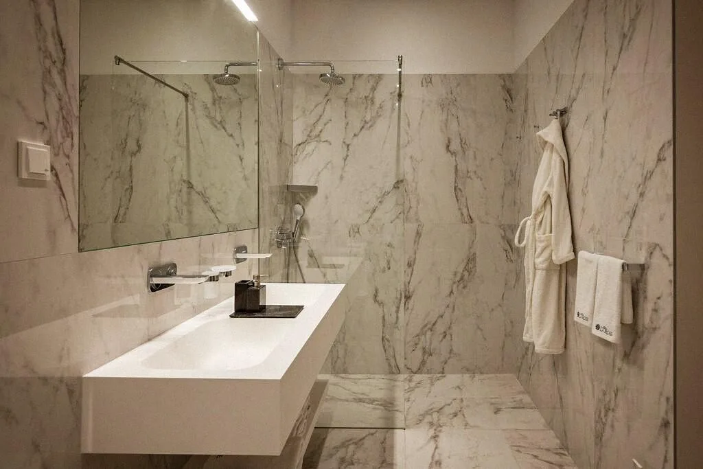 Marble bathroom with walk-in shower at Villa La Rose