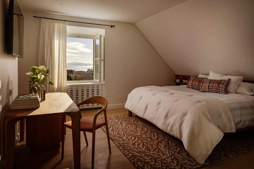 Attic bedroom with king-size bed and desk at Villa La Rose