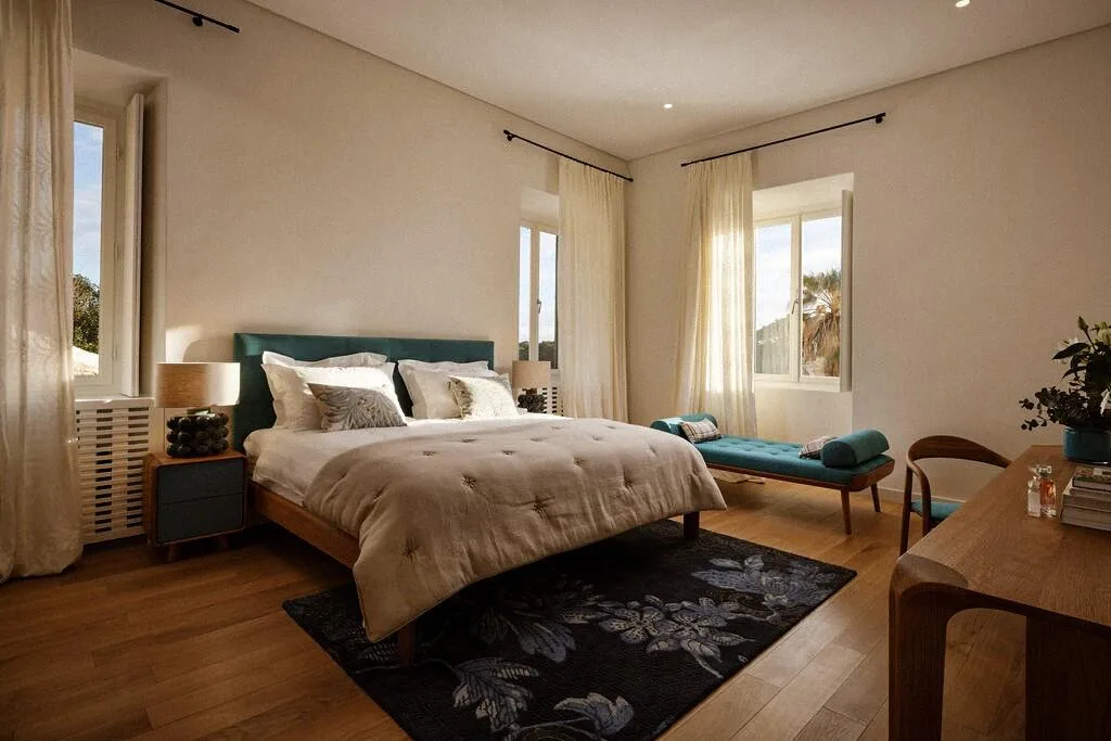 Bedroom with king-size bed and teal headboard at Villa La Rose