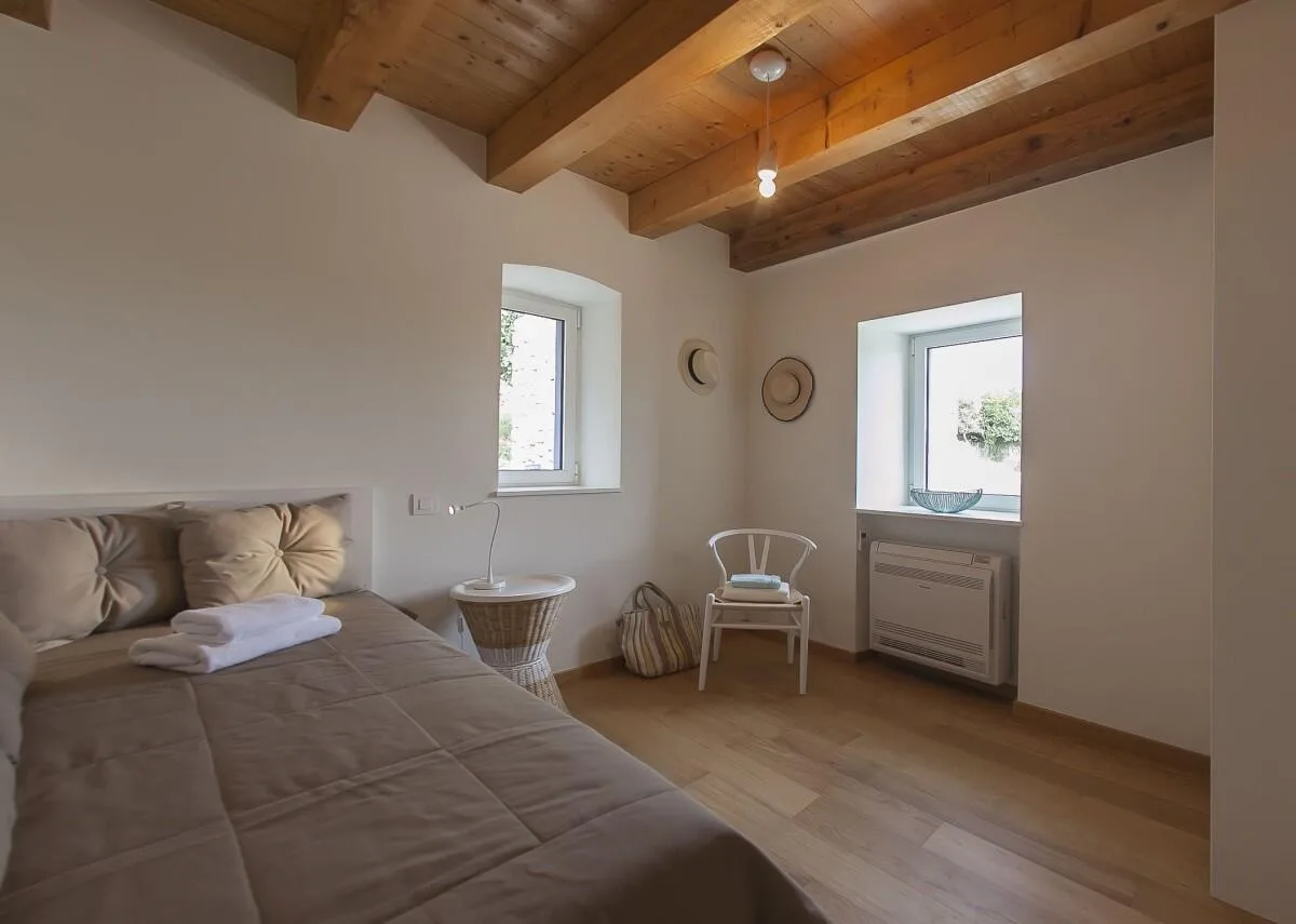 Bedroom with king-size bed and window at Villa Ella, Šipan