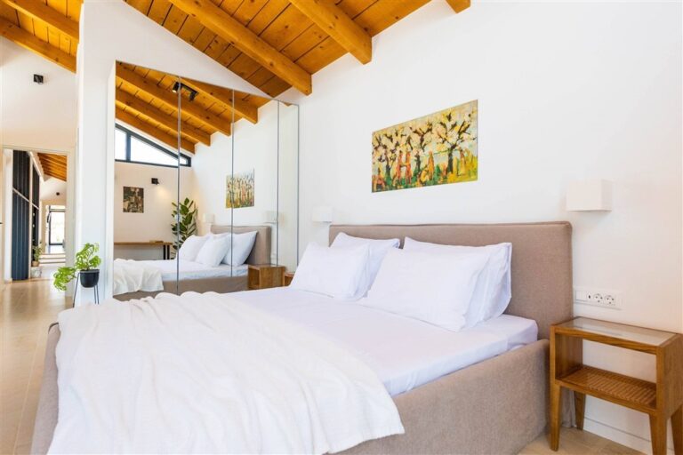 Schlafzimmer mit Kingsize-Bett und Kunstwerken in der Villa Moa