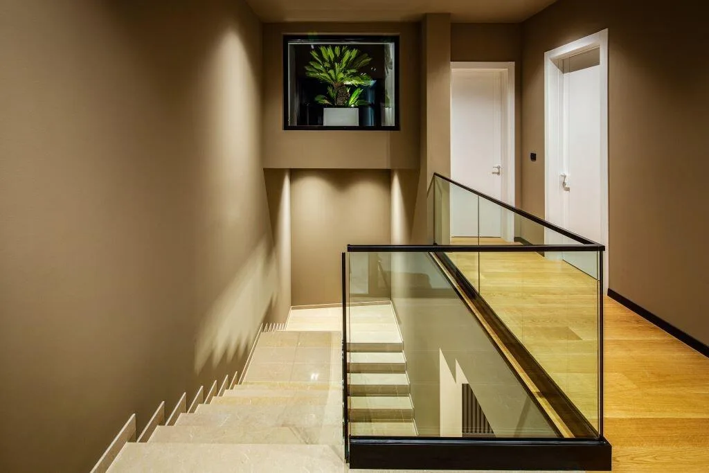 Hallway with glass staircase at Villa La Frida