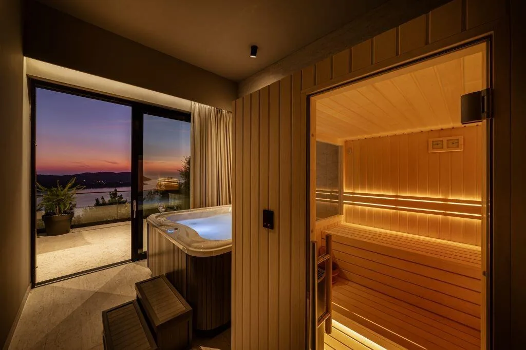 Private sauna and hot tub with sunset sea view at Villa La Frida