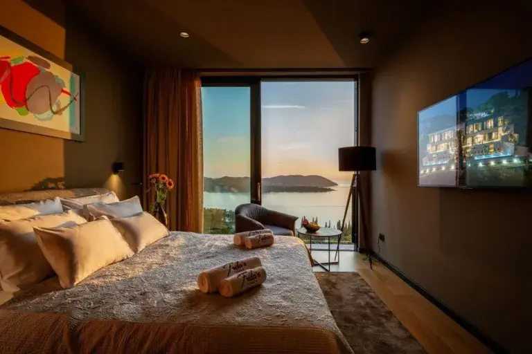 Bedroom with king-size bed and sunset sea view at Villa La Frida