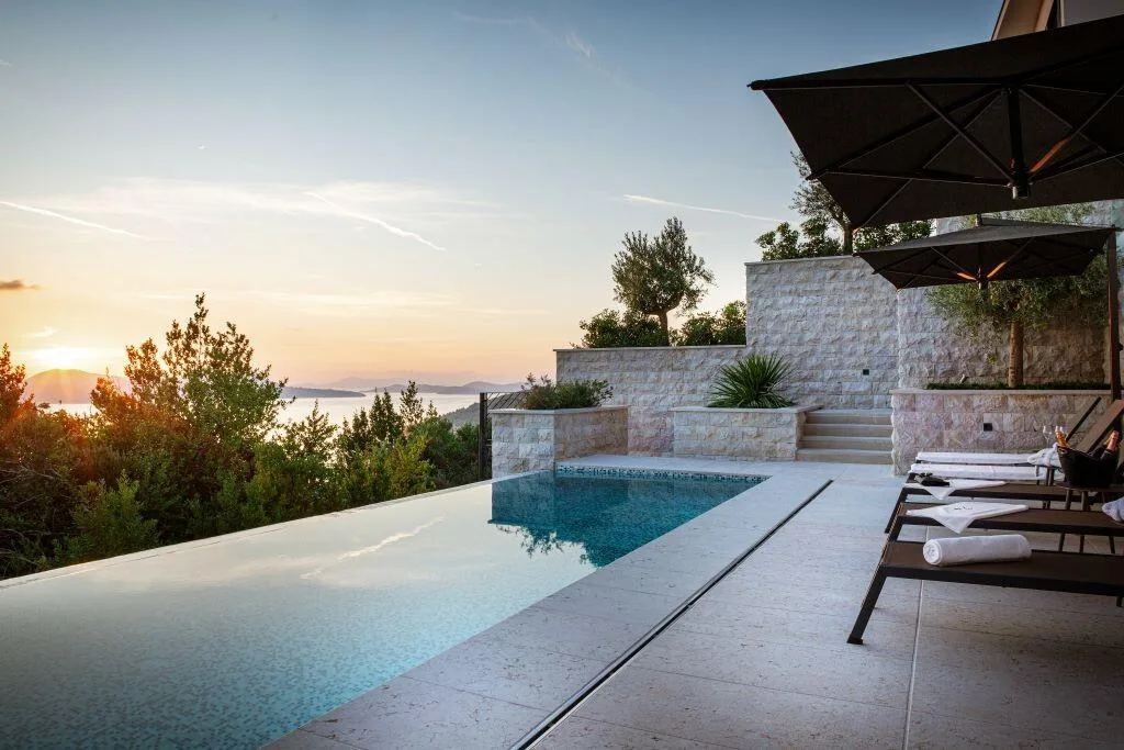Infinity pool edge and terrace at sunset at Villa La Frida