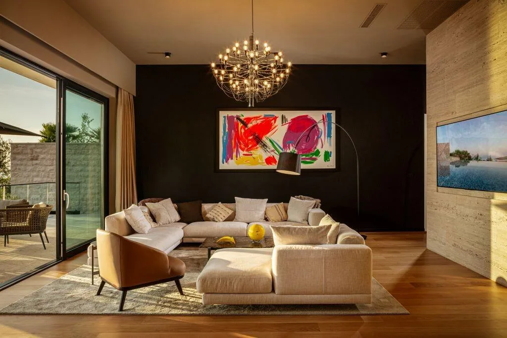 Lounge with designer sofas and colourful artwork at Villa La Frida