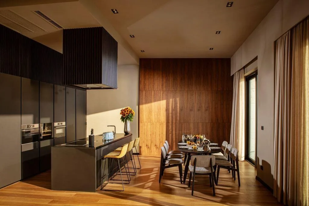 Kitchen and dining table with warm lighting at Villa La Frida