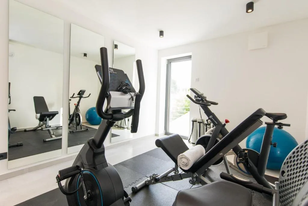 Private gym with exercise bikes and weights at Villa Helia