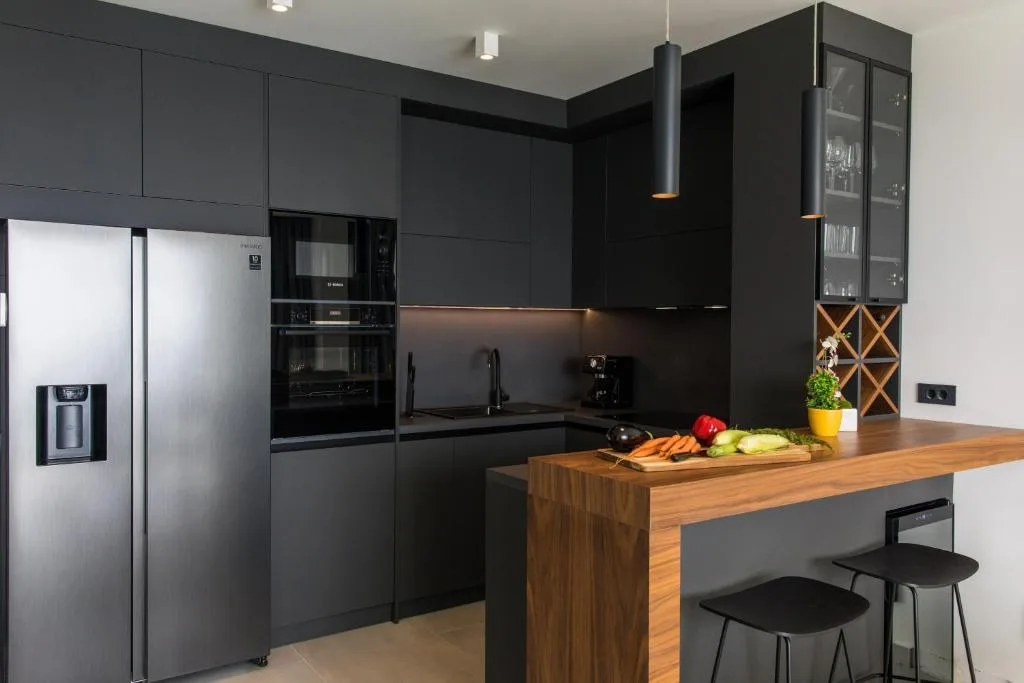 Dark designer kitchen with wooden breakfast bar at Villa Helia
