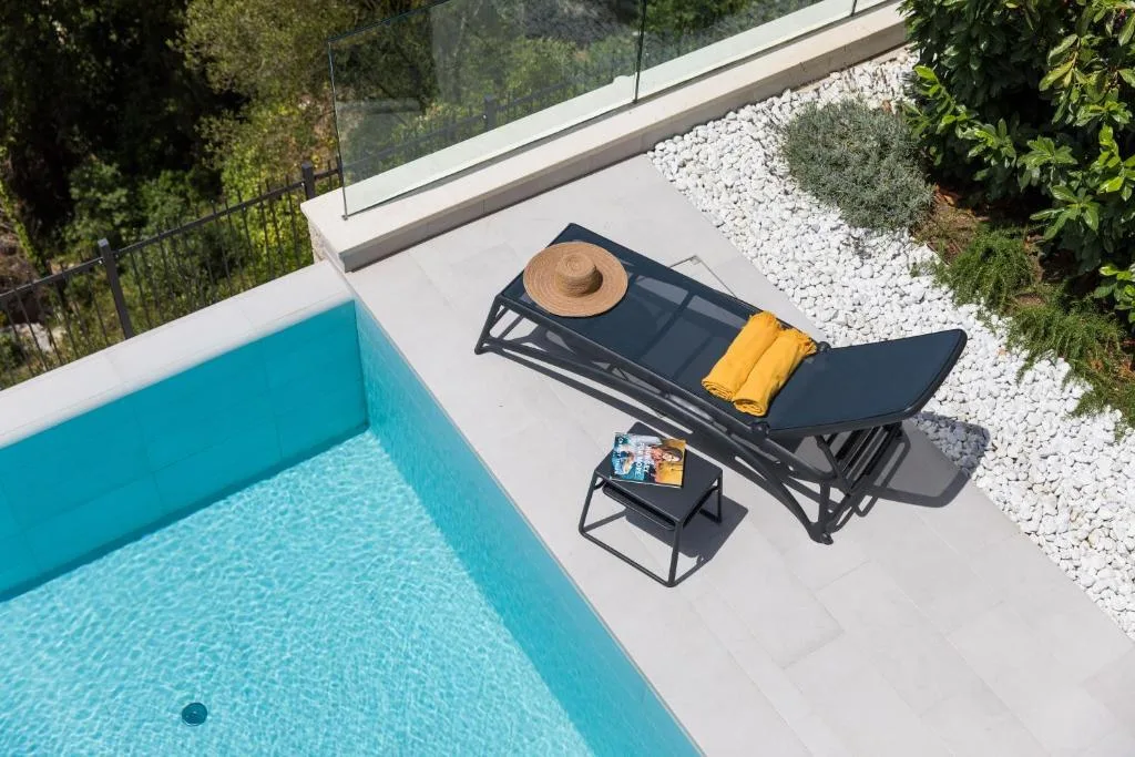 Overhead view of a lounger beside the pool at Villa Helia
