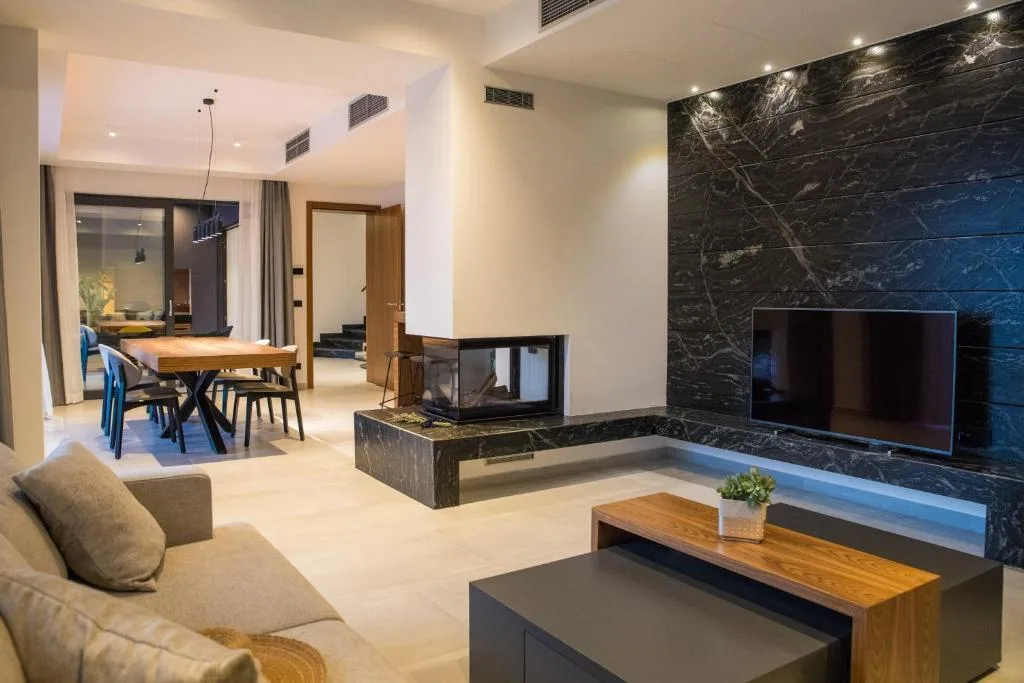 Living and dining room with fireplace at Villa Helia