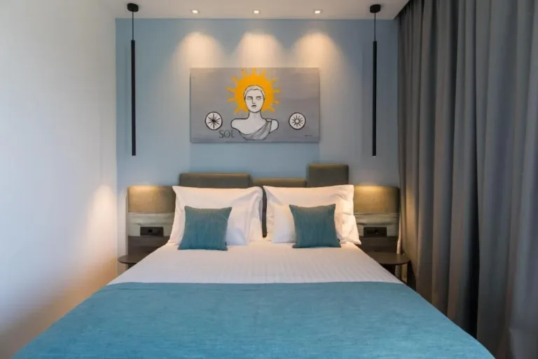 Bedroom with king-size bed and decorative artwork at Villa Helia