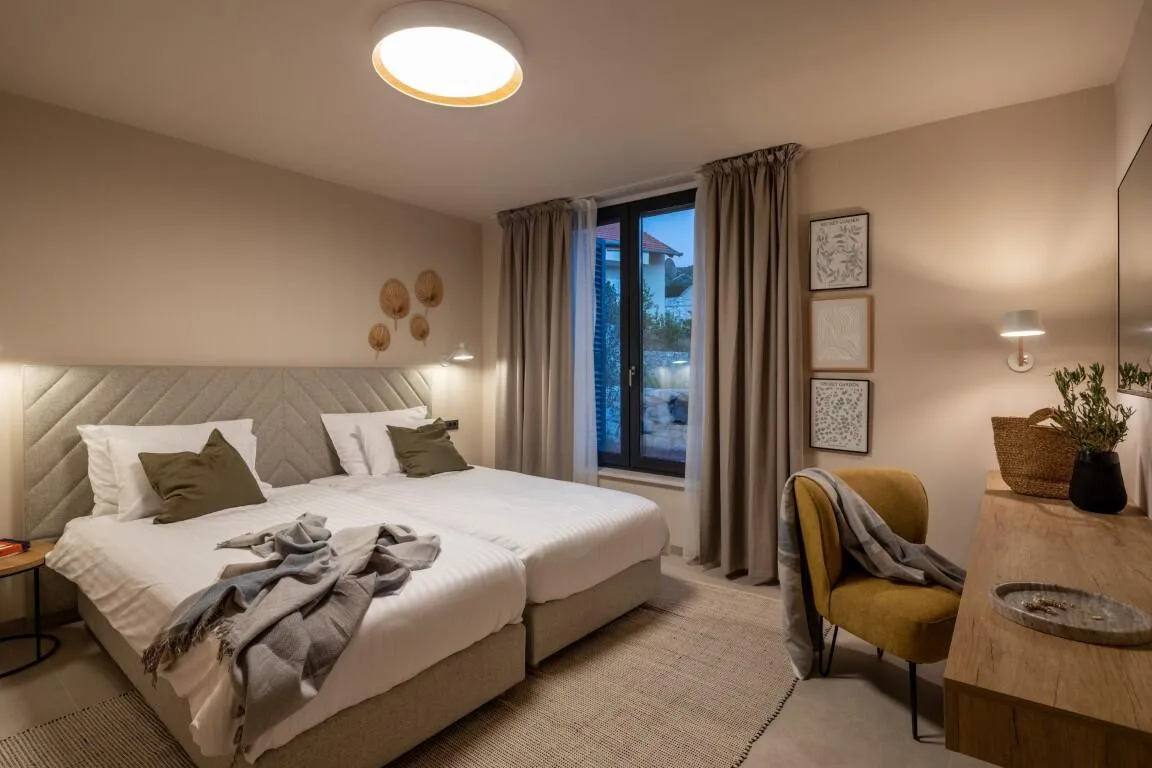 Bedroom with king-size bed and reading chair at Villa Petra