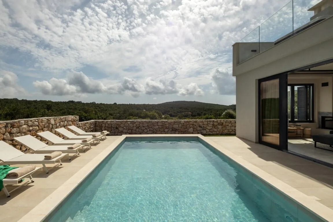 Long heated swimming pool with loungers at Villa Petra, Majkovi