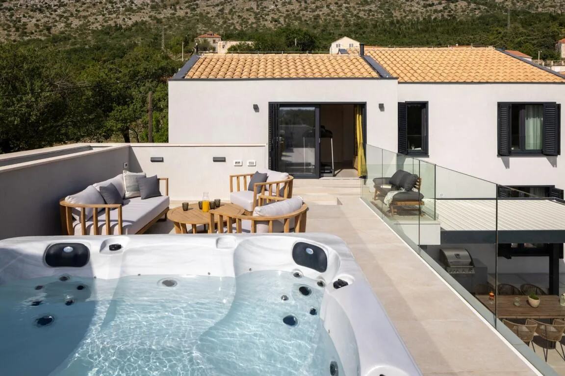 Rooftop terrace with outdoor hot tub and lounge at Villa Petra