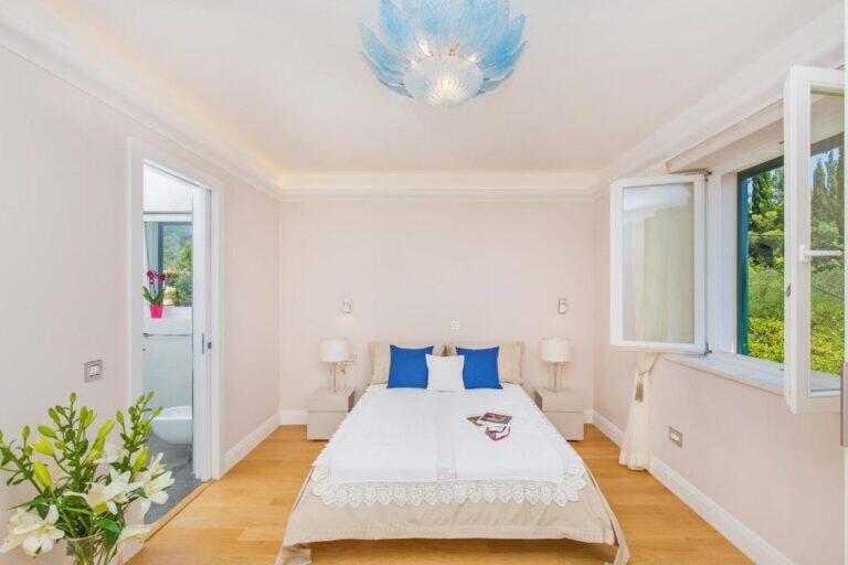 Schlafzimmer mit Doppelbett und Gartenfenster in der Villa Vintage