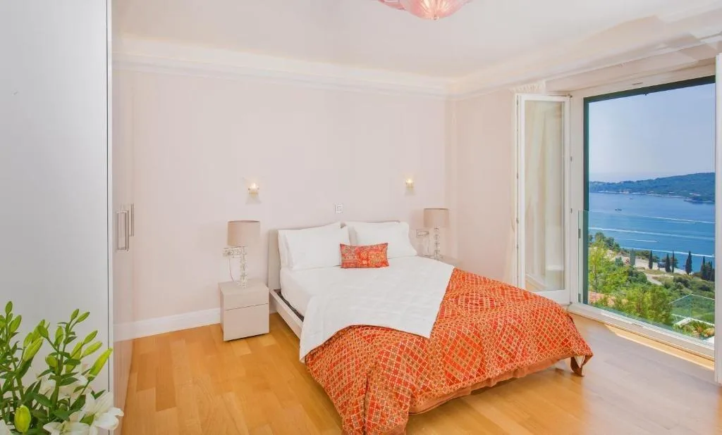 Bedroom with open windows and sea view at Villa Vintage