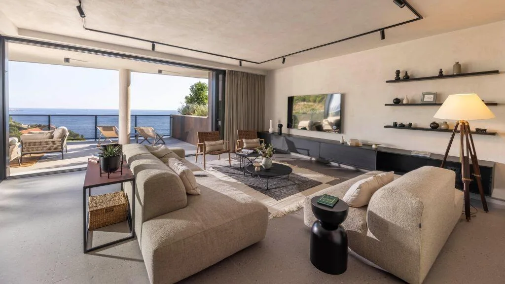 Living room with sofas and sea-view windows at Villa Atreeum