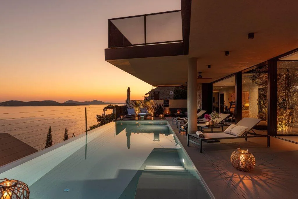 Infinity pool and terrace lanterns at sunset at Villa Atreeum