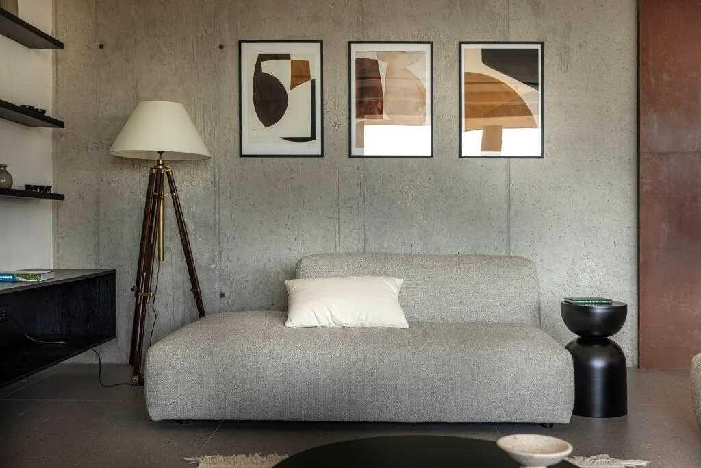 Grey sofa, floor lamp and framed artwork at Villa Atreeum