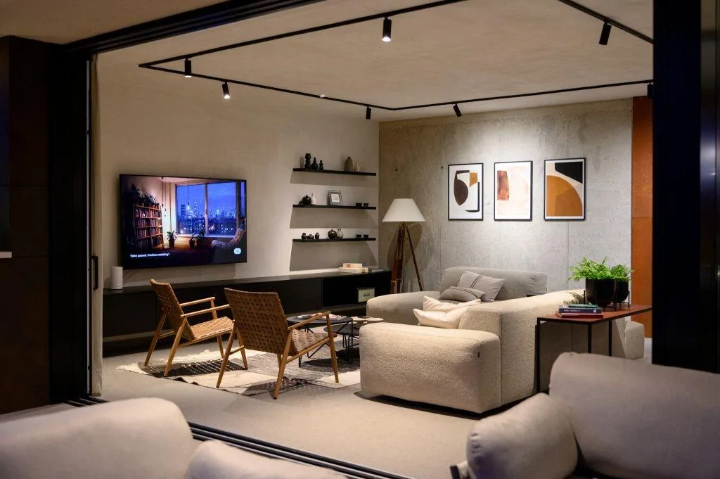 Lounge with sofas, TV and modern artwork at Villa Atreeum