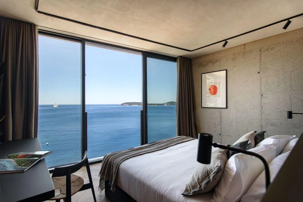 Bedroom with king-size bed and floor-to-ceiling sea views at Villa Atreeum